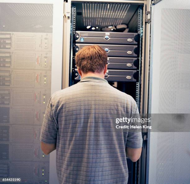technician working in a server room - old computer back stock pictures, royalty-free photos & images