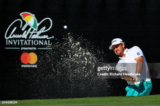 Graeme McDowell of Northern Ireland plays a shot from a bunker on the 17th hole during the second round of the Arnold Palmer Invitational Presented...