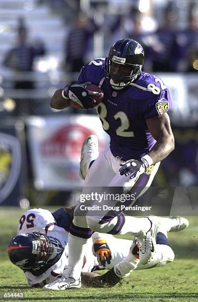 Shannon Sharpe of the Baltimore Ravens eludes a tackle by Al Wilson of the Denver Broncos and runs for a 58-yard touchdown to give the Ravens a 14-3...