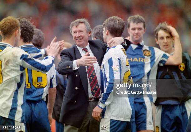 Manchester United player David Beckham and team mates celebrate with manager Alex Ferguson after Manchester United claim the title after the FA...