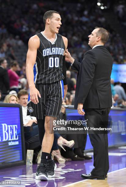 Head coach Frank Vogel of the Orlando Magic talks with his player Aaron Gordon as Gordon walks off the court against the Sacramento Kings during an...