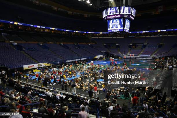 Wrestlers gather on the mats for skin checks and weigh-ins before session three of the NCAA Wrestling Championships on March 17, 2017 at the...