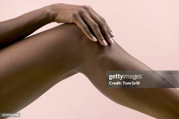woman's hand on knee - hand on knee ストックフォトと画像