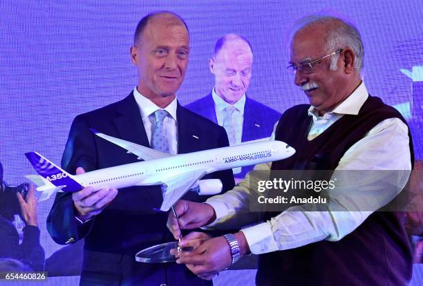 Tom Enders, chief executive officer of Airbus Group NV, , and Ashok Gajapathi Raju India's minister of civil aviation, stand with scale model during...