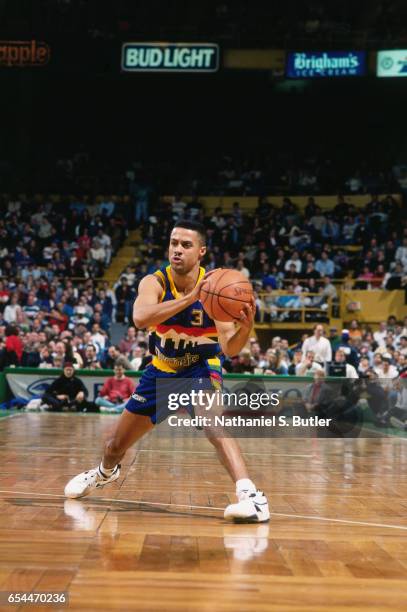 Chris Jackson of the Denver Nuggets passes the ball against against the Boston Celtics circa 1993 at the Boston Garden in Boston, Massachussetts....