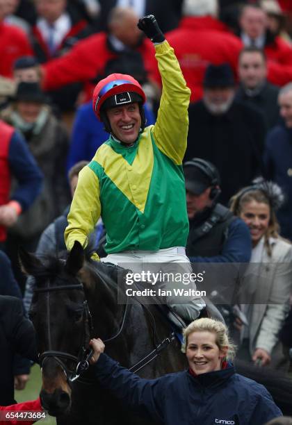 Jockey Robbie Power celebrates after steering Sizing John to victory in the Timico Cheltenham Gold Cup Chase during Gold Cup Day on day four of the...