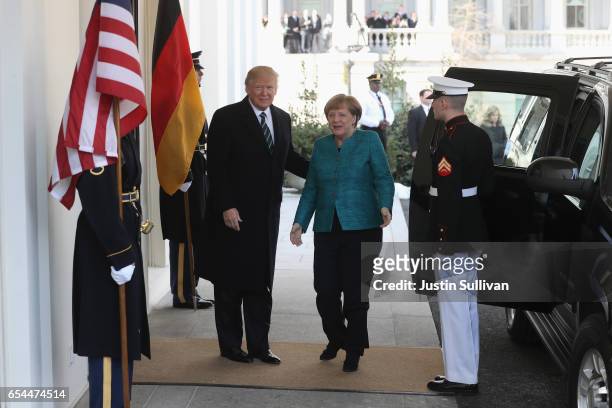 President Donald Trump greets German Chancellor Angela Merkel as she arrives to the White House on March 17, 2017 in Washington, DC.