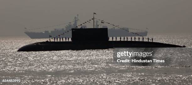The sailors on board the Indian submarines perform during the President's Fleet Review 2011 in Mumbai on Tuesday.