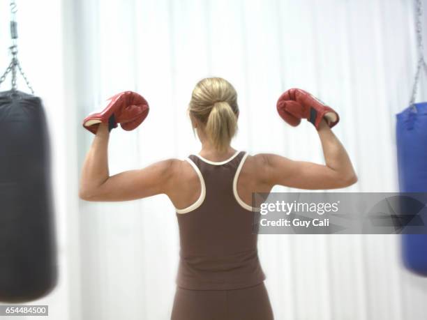 boxer flexing her muscles - cali morales stock pictures, royalty-free photos & images