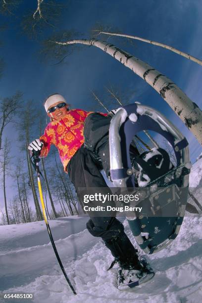 little girl showing snow boot - floral pattern jacket stock-fotos und bilder