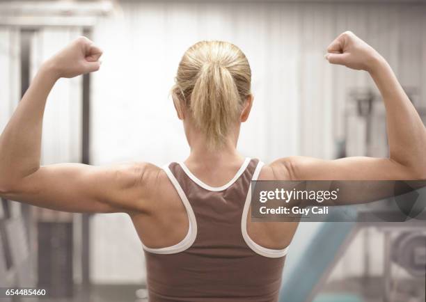 woman flexing her muscles - cali morales stock pictures, royalty-free photos & images