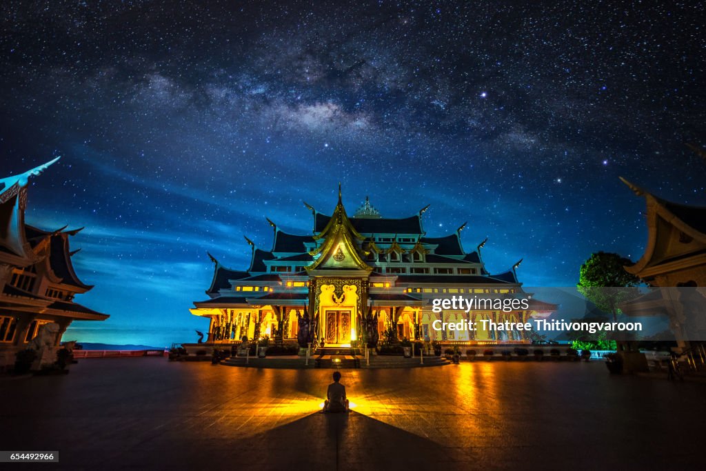 Milky way galaxy with Bright Stars and space dust of Thai Temple ,the northeast of Thailand : Wat Pa Phu Kon