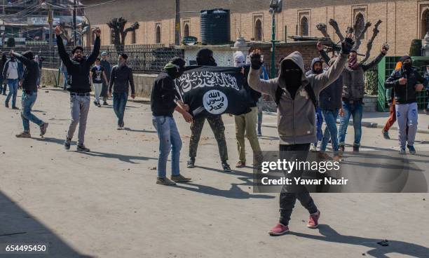 Kashmiri Muslim protester hold an ISIS flag as they chant anti Indian slogans during a protest against recent civilian killings by Indian forces, on...