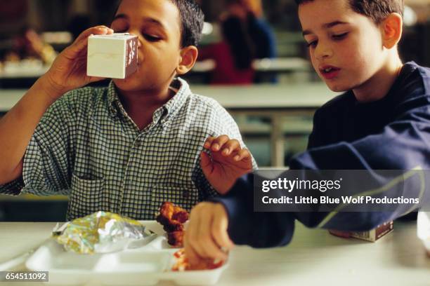 boys eating lunch in cafeteria - chocolate milk stock pictures, royalty-free photos & images