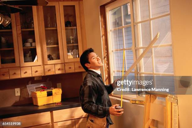 measuring a kitchen window - lawrence lader stock pictures, royalty-free photos & images