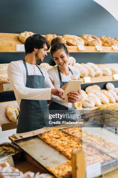 bakers using a tablet - ipad kiosk stock pictures, royalty-free photos & images