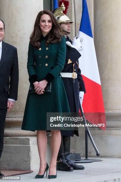 Catherine, Duchess of Cambridge poses not far from her husband Prince William, Duke of Cambridge before their meeting with French President Francois...