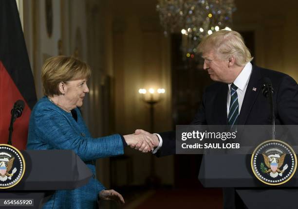 President Donald Trump and Germany's Chancellor Angela Merkel shake hands after a press conference in the East Room of the White House March 17, 2017...