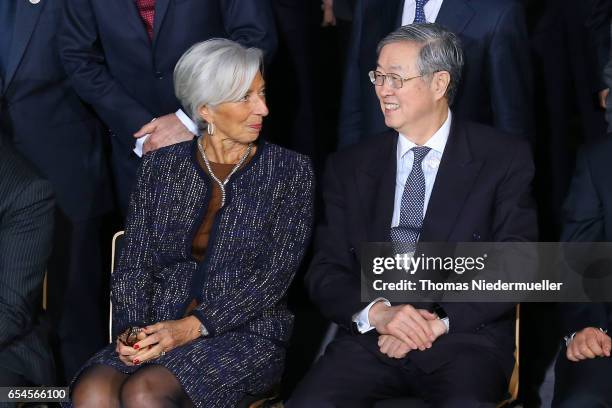 People's Bank of China Governor Zhou Xiaochuan talks to Christine Lagarde, managing director of the International Monetary Fund during the family...