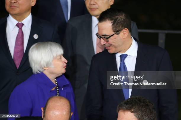 Treasury Secretary Steven Mnuchin talks to Janet Yellen, Chair of the Board of Governors of the Federal Reserve System at the family photo during the...