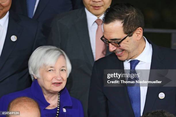 Treasury Secretary Steven Mnuchin talks to Janet Yellen, Chair of the Board of Governors of the Federal Reserve System at the family photo during the...