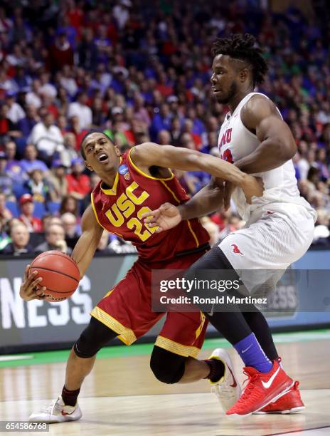 De'Anthony Melton of the USC Trojans handles the ball against Semi Ojeleye of the Southern Methodist Mustangs in the second half during the first...