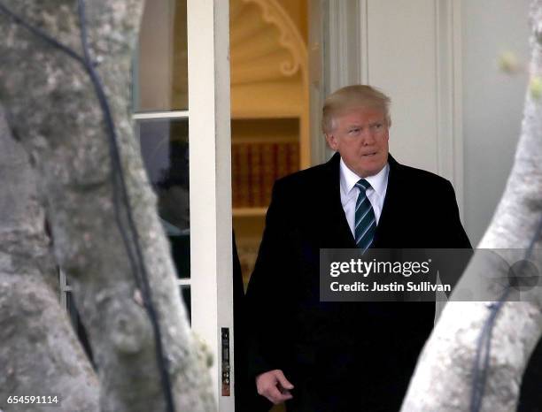 President Donald Trump leaves the Oval Office as he prepares to depart the White House on March 17, 2017 in Washington, DC. President Trump is...