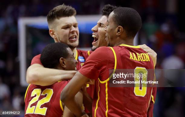 De'Anthony Melton, Nick Rakocevic, Bennie Boatwright and Shaqquan Aaron of the USC Trojans celebrate after defeating the Southern Methodist Mustangs...