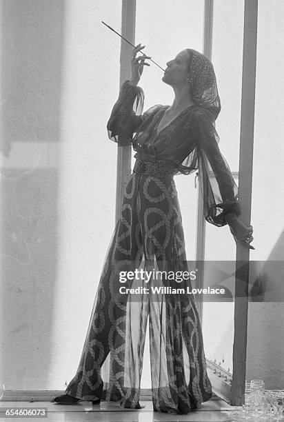 Jay models a blouse and wide-legged trousers in chiffon, UK, 13th July 1971.