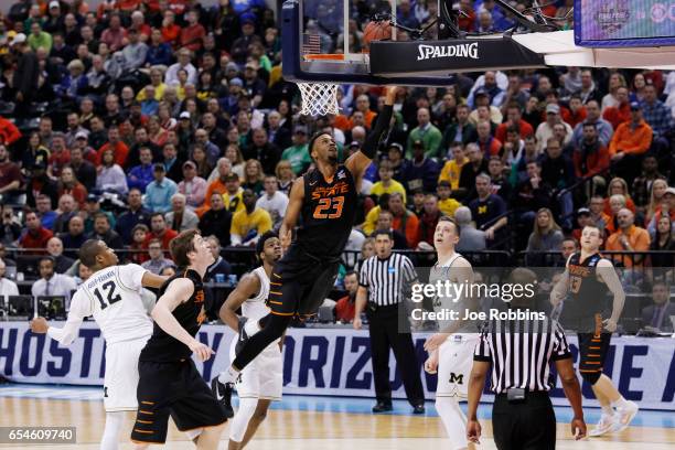 Leyton Hammonds of the Oklahoma State Cowboys drives to the basket against the Michigan Wolverines during the first round of the 2017 NCAA Men's...