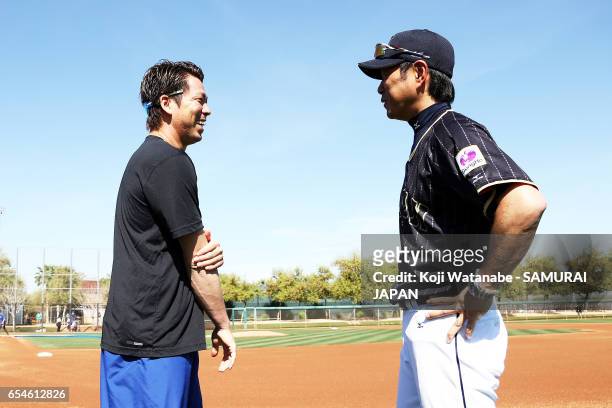 Manager Hiroki Kokubo of Japan and Kenta Maeda of the Los Angeles Dodgers speak during a workout ahead of the World Baseball Classic Championship...