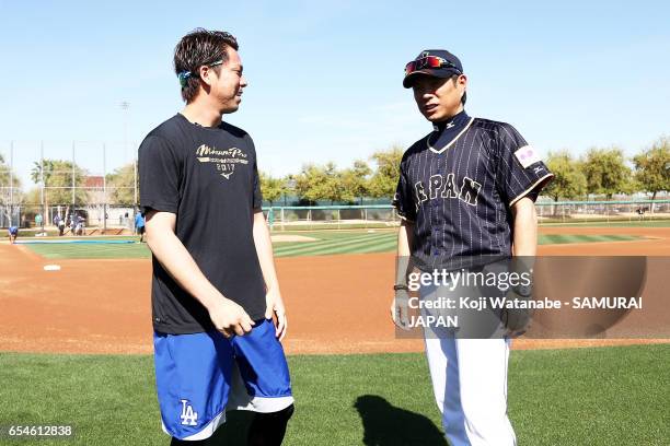 Manager Hiroki Kokubo of Japan and Kenta Maeda of the Los Angeles Dodgers speak during a workout ahead of the World Baseball Classic Championship...