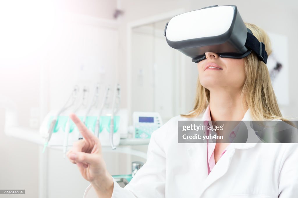 Female dentist using virtual reality headset