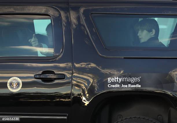 President Donald Trump and his son, Barron Trump sit in a vehicle together after arriving on Air Force One at the Palm Beach International Airport to...