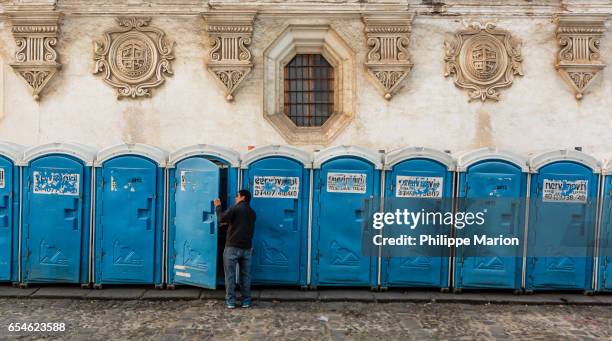 man enters public bathroom - klooster stock-fotos und bilder