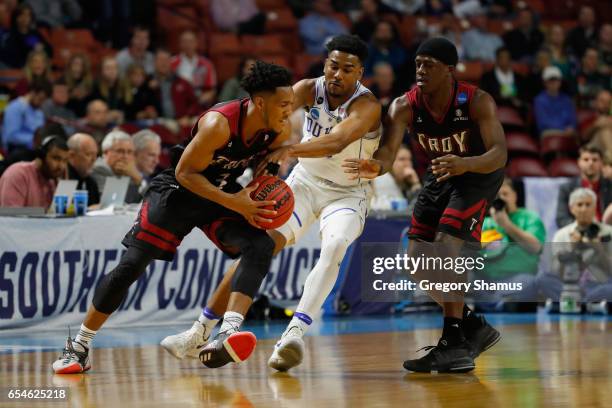 Wesley Person of the Troy Trojans drives against Matt Jones of the Duke Blue Devils in the first half during the first round of the 2017 NCAA Men's...