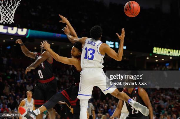 Matt Jones of the Duke Blue Devils goes for a rebound against Wesley Person of the Troy Trojans in the second half during the first round of the 2017...