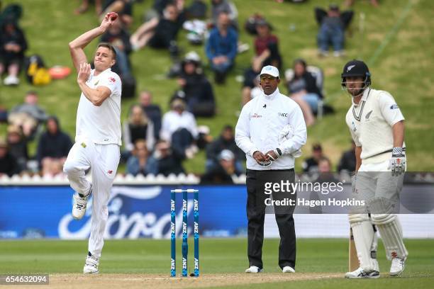 Morne Morkell of South Africa bowls while umpire Kumar Dharmasena of Sri Lanka and Neil Broom of New Zealand look on during day three of the test...