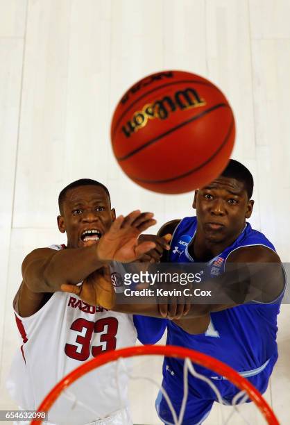 Moses Kingsley of the Arkansas Razorbacks rebounds against Angel Delgado of the Seton Hall Pirates during the first round of the 2017 NCAA Men's...