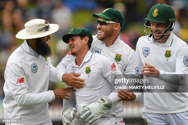 South Africa's Quinton de Kock celebrates catching New Zealand's Neil Broom with teammates Hashim Amla , captain Faf du Plessis and Stephen Cook...