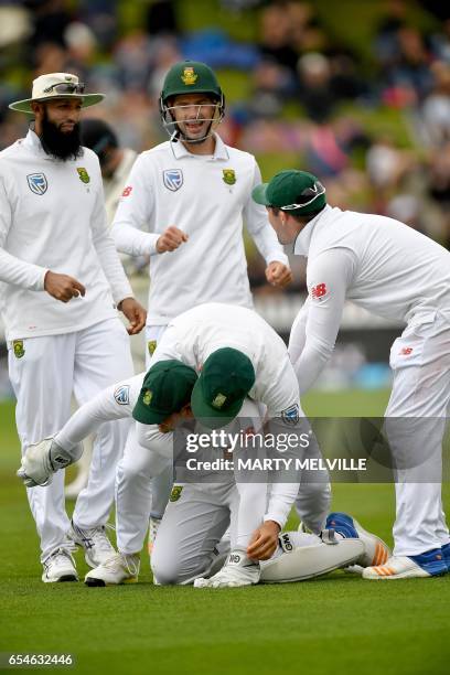 South Africa's Quinton de Kock celebrates catching New Zealand's Neil Broom with teammates captain Faf du Plessis , Hashim Amla , Stephen Cook and...