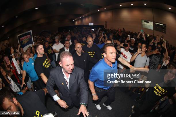 Arnold Schwarzenegger walks through the crowds on the expo floor during the 2017 Arnold Classic at The Melbourne Convention and Exhibition Centre on...