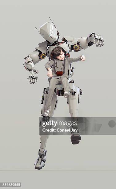 young girl controlling powerful robot - bionic stock-fotos und bilder