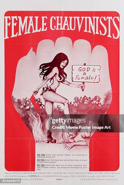 Image contains suggestive content.)A woman burns her bra while waving a sign reading 'God is female!' and stamping on a helpless man, on a poster for...