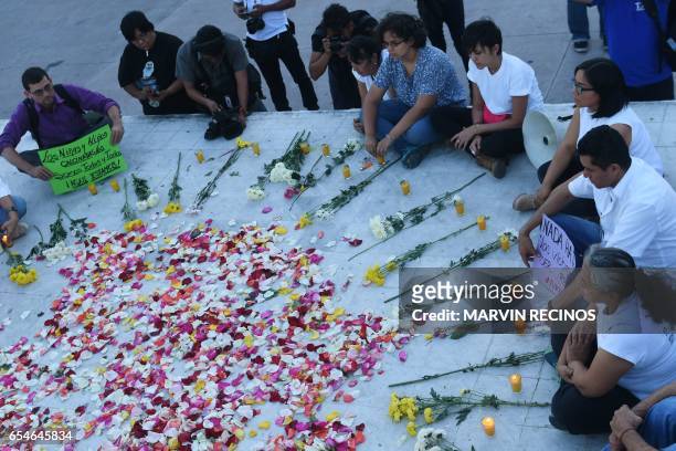 Human rights activists protest against femicide and violence in a demonstration at El Salvador del Mundo square in San Salvador on March 17, 2017 to...