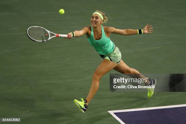 Elena Vesnina of Russia plays a forehand against Kristina Mladenovic of France in their semi final match during day twelve of the BNP Paribas Open at...