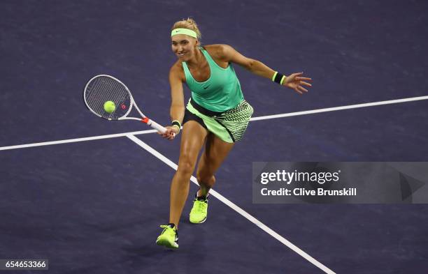 Elena Vesnina of Russia plays a forehand volley against Kristina Mladenovic of France in their semi final match during day twelve of the BNP Paribas...