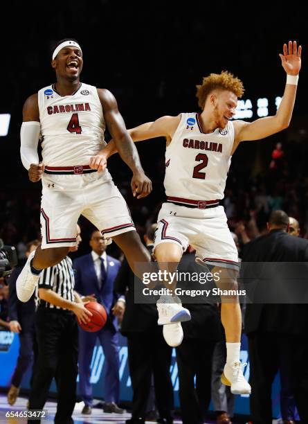 Rakym Felder and Hassani Gravett of the South Carolina Gamecocks celebrate their 93-73 win over the Marquette Golden Eagles during the first round of...