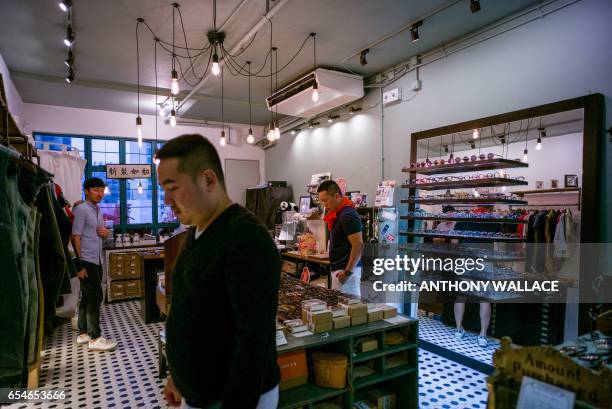 In this picture taken on March 17 customers browse locally designed fashion label goods in an independant shop in Hong Kong. Soulless supermalls...