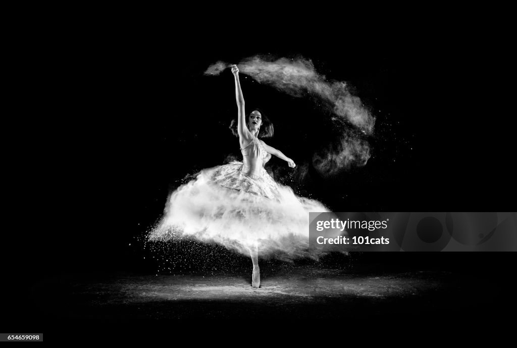 Beautiful ballet dancer, dancing with powder on stage